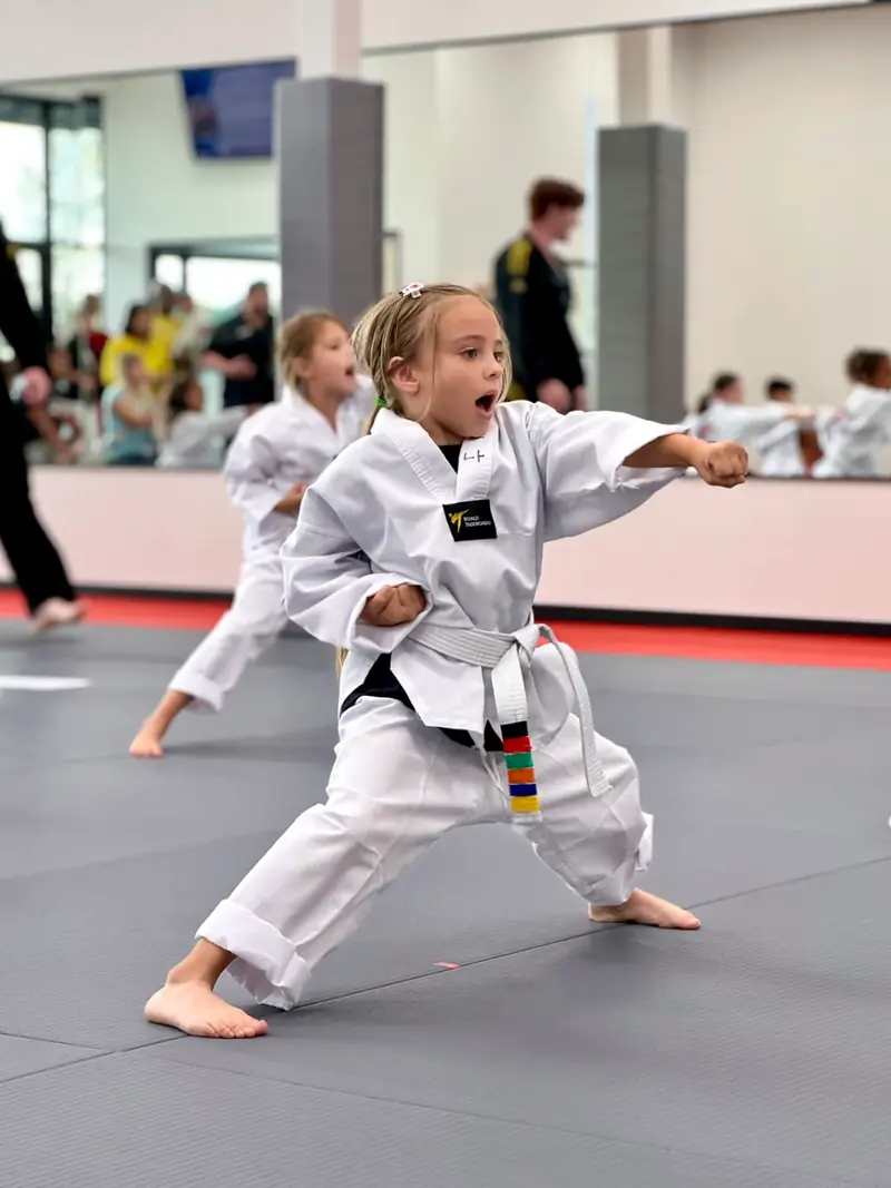 A young student throwing a punch in class
