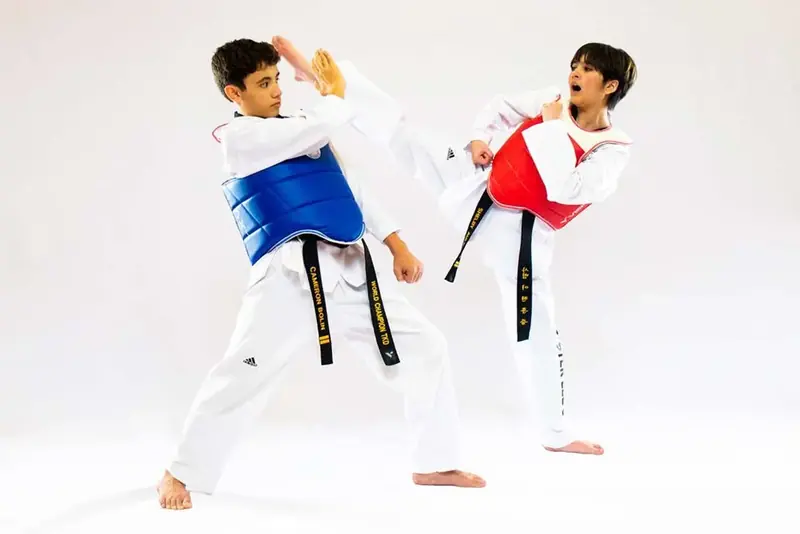 Two children sparring in chest protectors